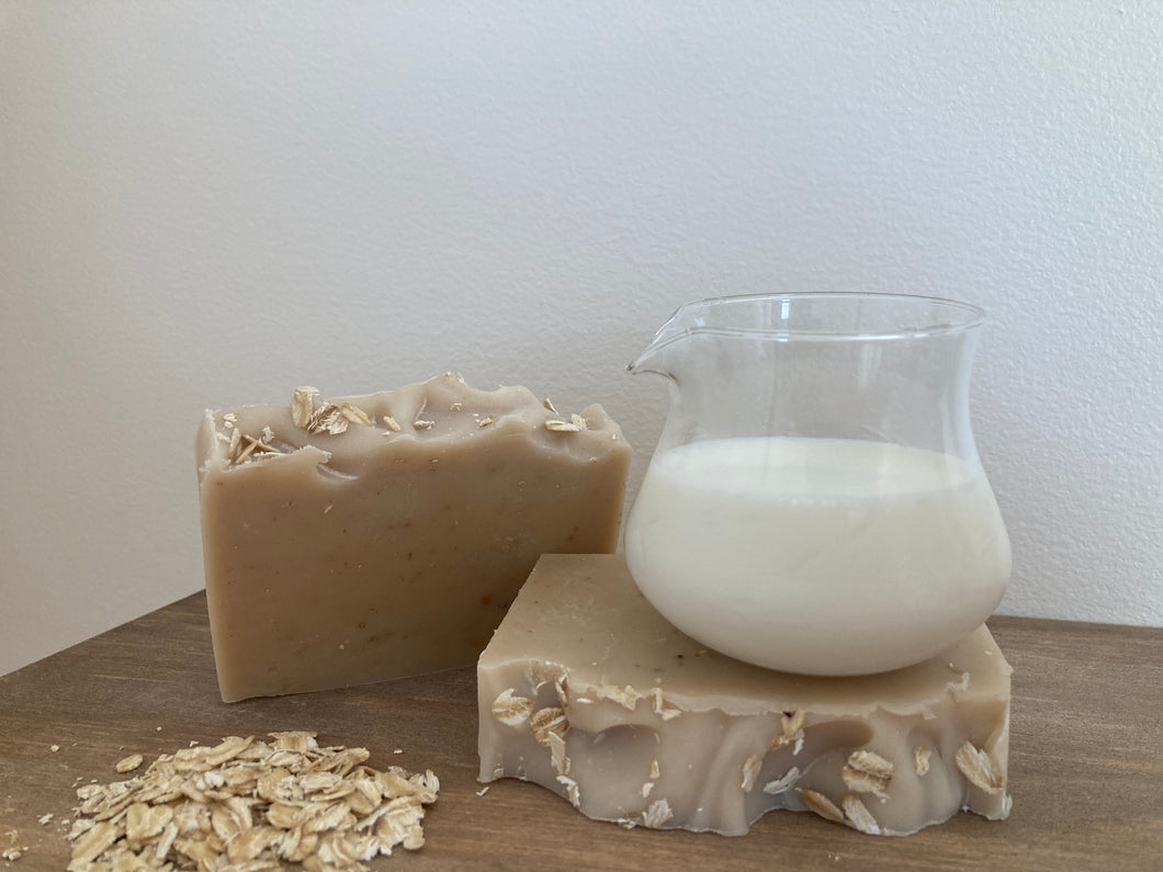 Goat milk oat and honey soap bars. Pale creamy color, sprinkled with oats.